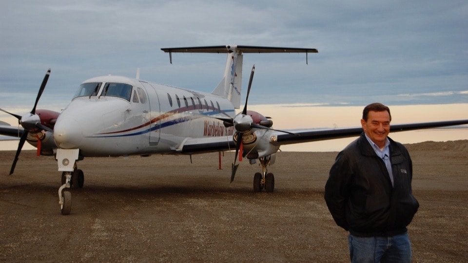 Pilot standing in front of Warbelow's Air turboprop aircraft