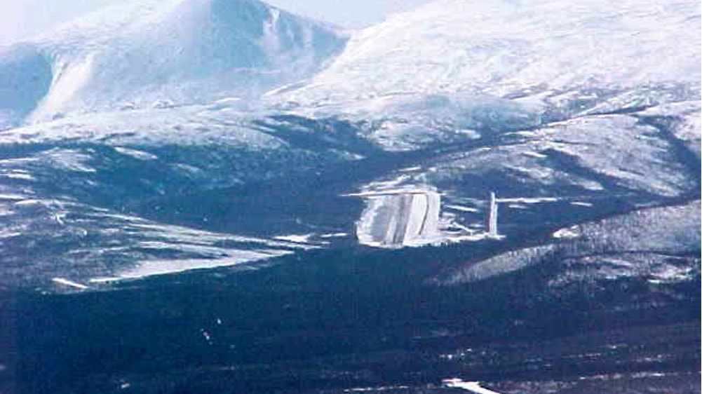 Aerial view of Indian Mountain remote airstrip nestled in a snowy Alaska valley