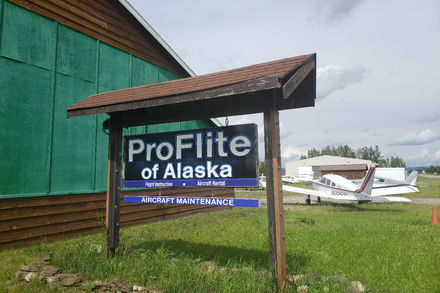 ProFlite of Alaska sign at the airport with aircraft in the background