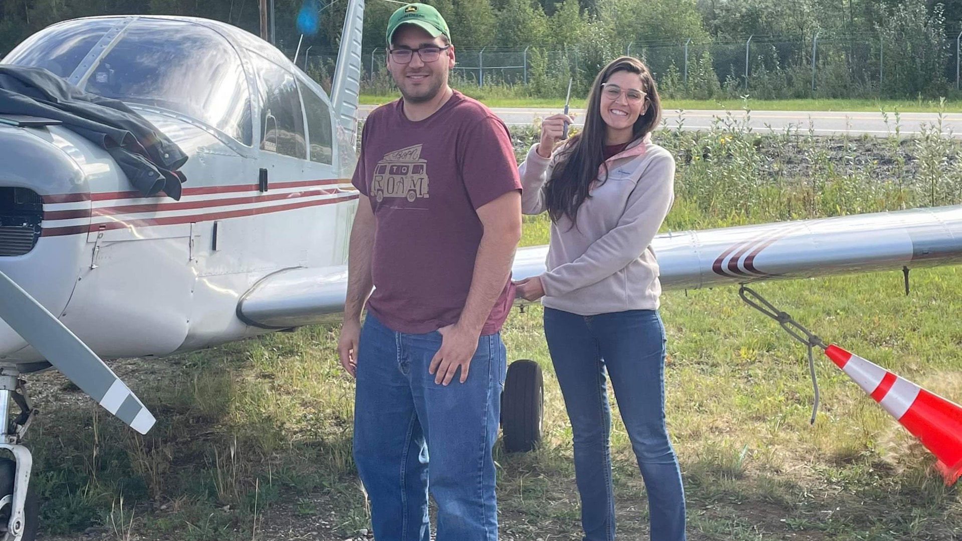 Student and instructor celebrating a solo flight next to a ProFlite of Alaska aircraft