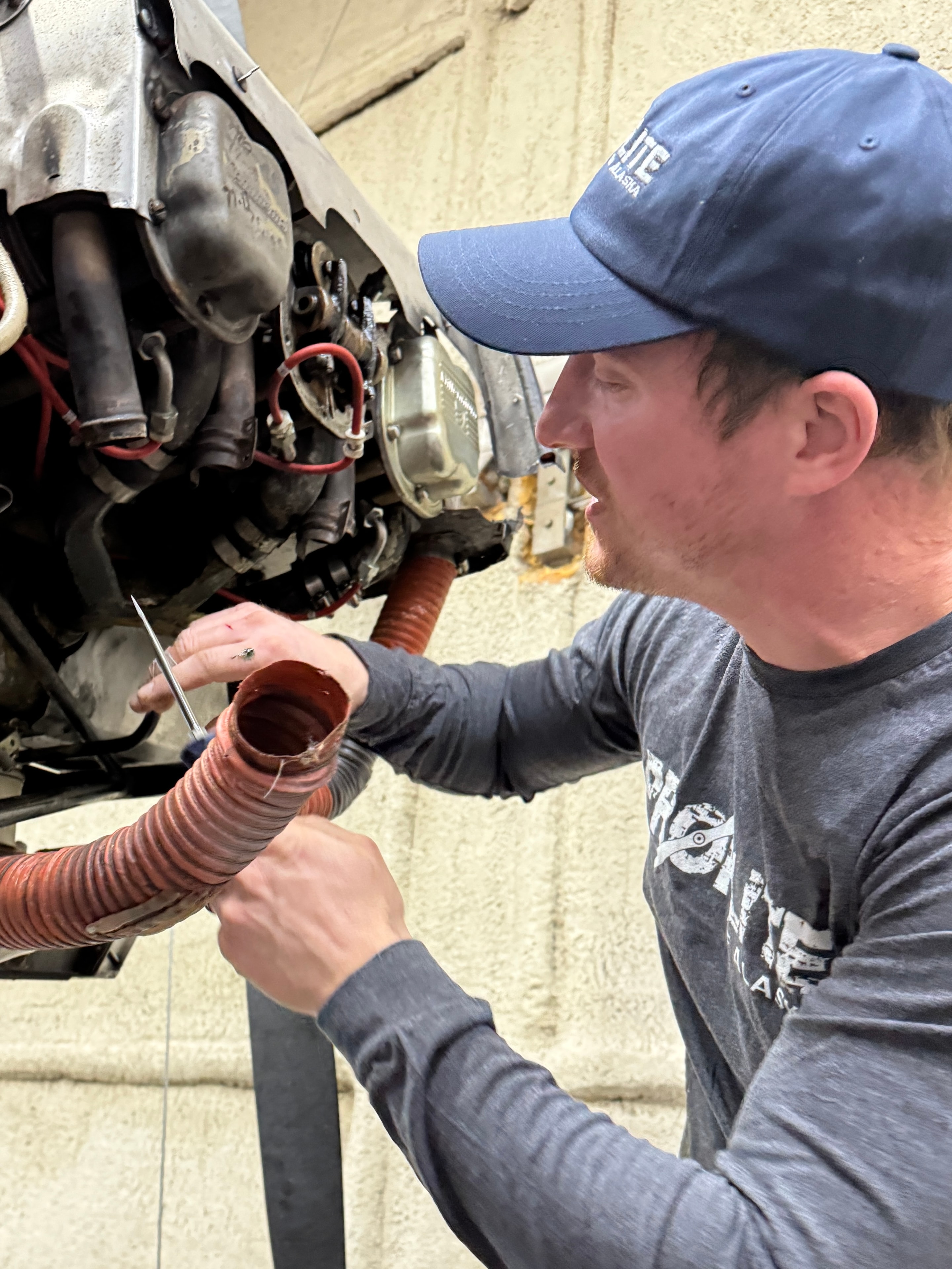 ProFlite of Alaska mechanic working on aircraft engine