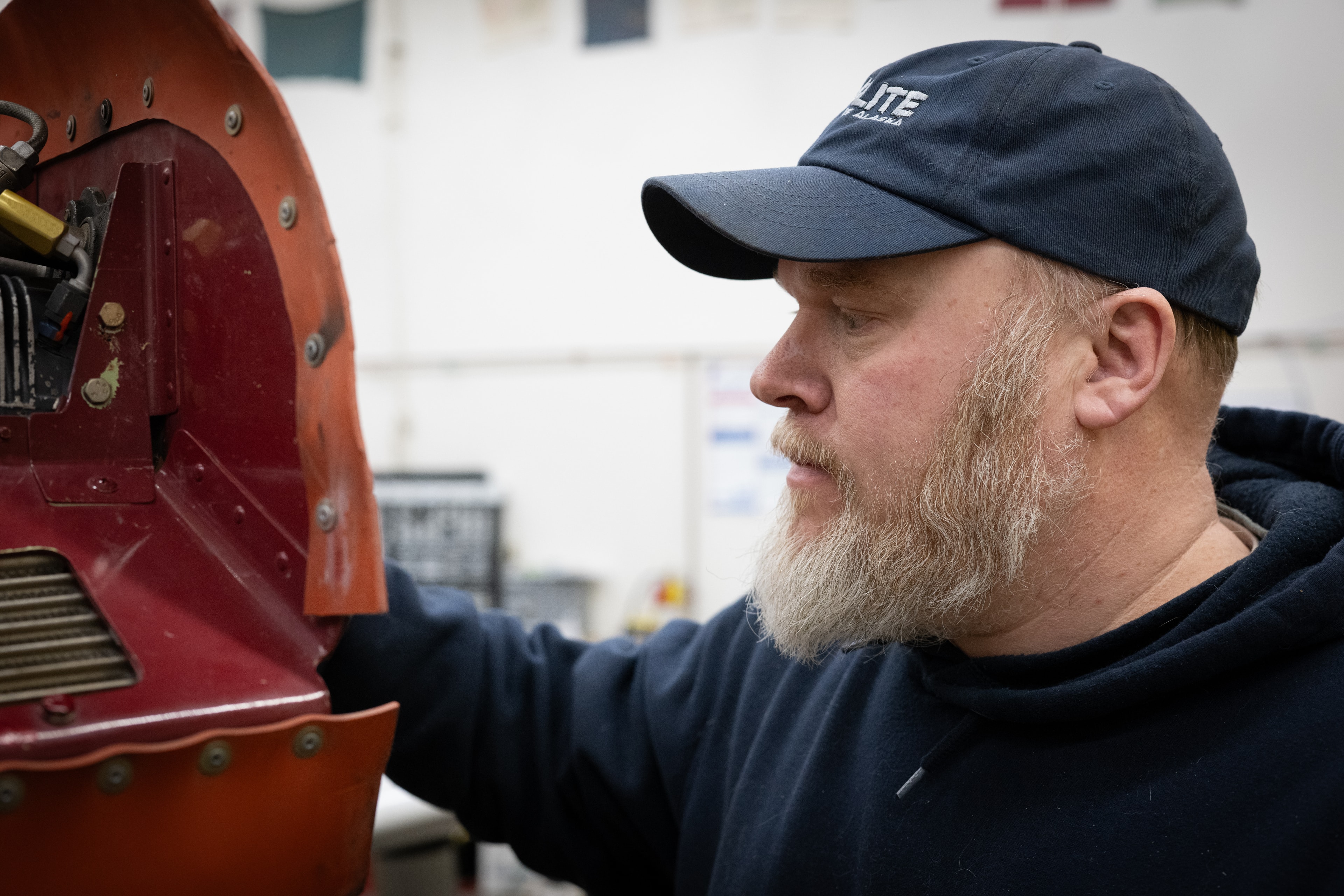 ProFlite of Alaska maintenance technician inspecting aircraft cowling