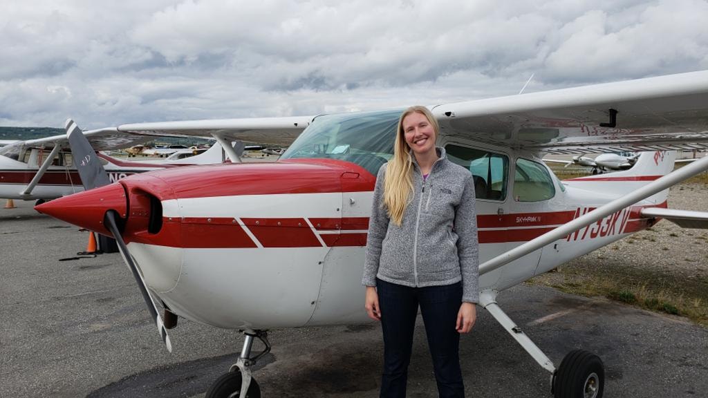 Student smiling next to ProFlite of Alaska Cessna Skyhawk before an introductory flight